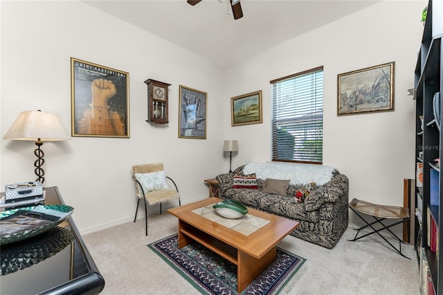 carpeted living room with ceiling fan