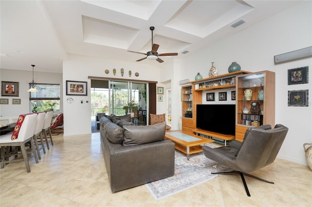 tiled living room with ceiling fan, beam ceiling, and coffered ceiling