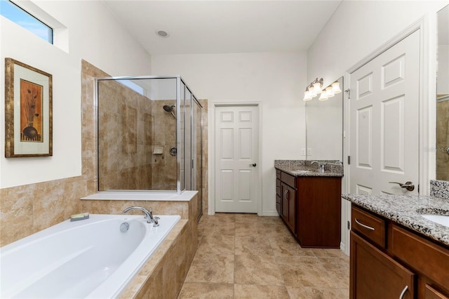 bathroom featuring tile patterned flooring, vanity, and separate shower and tub