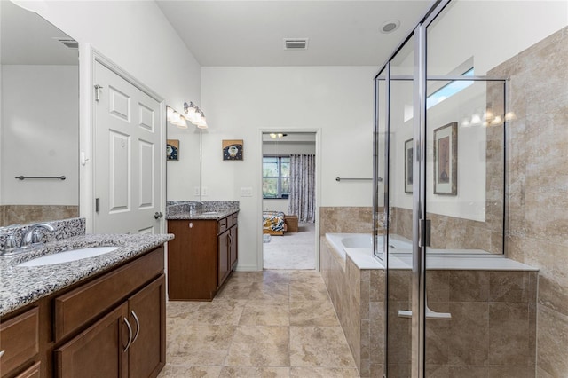 bathroom featuring vanity, tile patterned floors, and separate shower and tub