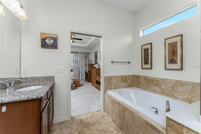 bathroom featuring tile patterned floors, vanity, a relaxing tiled tub, and ceiling fan