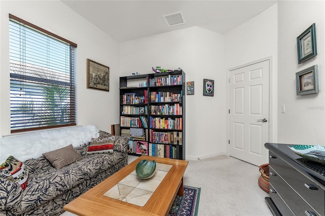 sitting room featuring light colored carpet