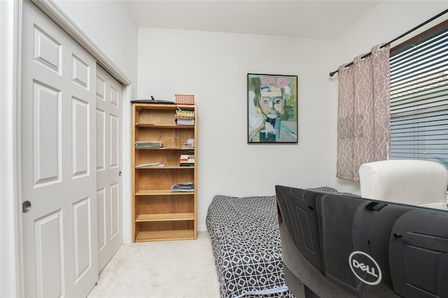 bedroom with light carpet and a closet