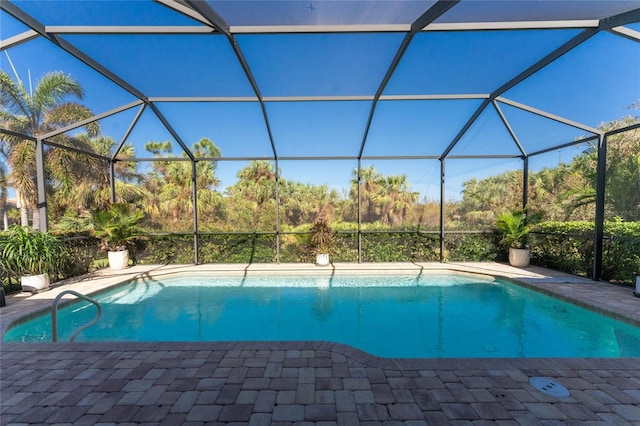 view of pool with a patio and a lanai