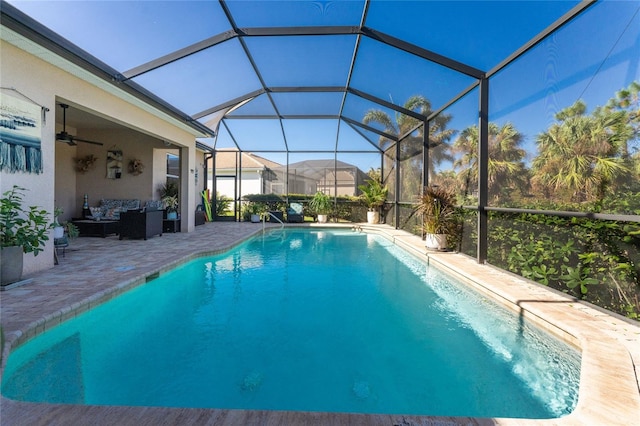 view of swimming pool featuring an outdoor living space, a patio area, a lanai, and ceiling fan