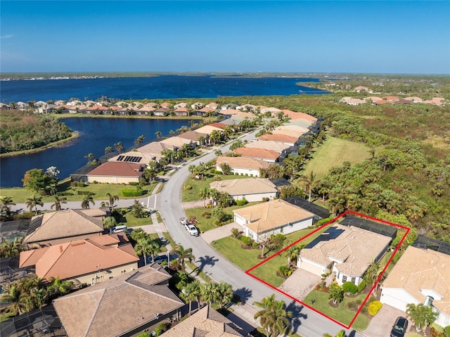 birds eye view of property with a water view