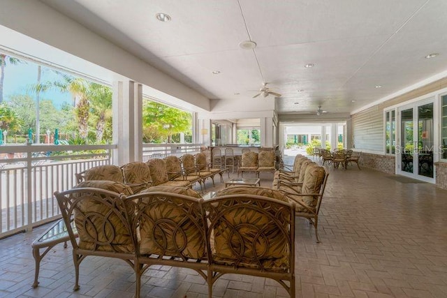 sunroom featuring ceiling fan