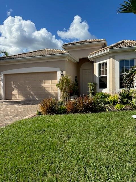 view of front of home featuring a garage and a front lawn