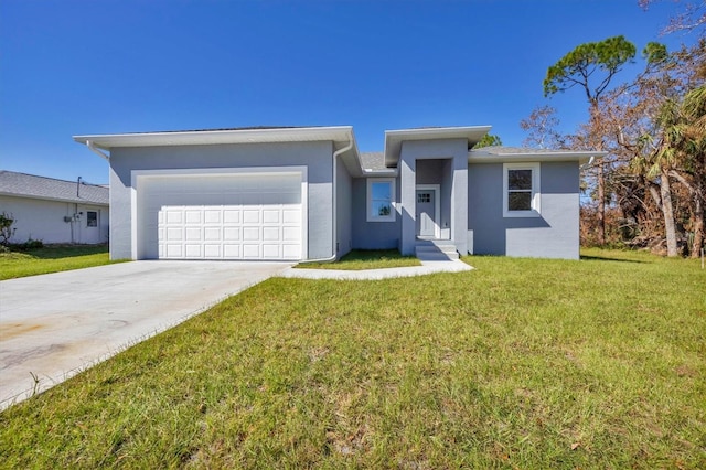 view of front of property with a front yard and a garage