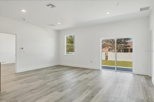 spare room with light hardwood / wood-style flooring