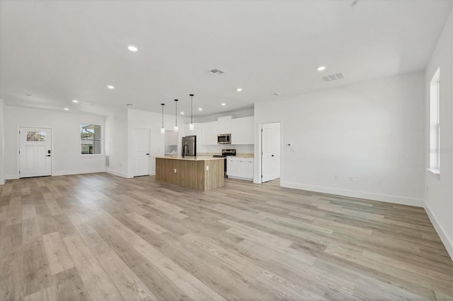 unfurnished living room featuring light hardwood / wood-style flooring