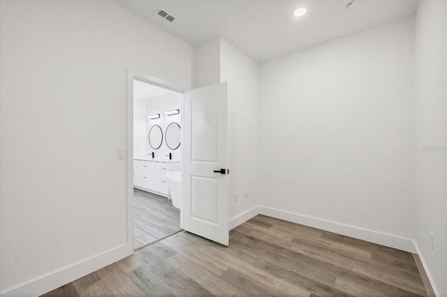 spare room with wood-type flooring