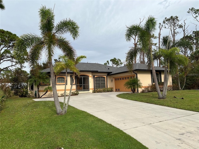 ranch-style home with a garage, stucco siding, a front yard, and concrete driveway