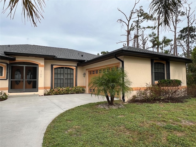 ranch-style house featuring a garage and a front lawn