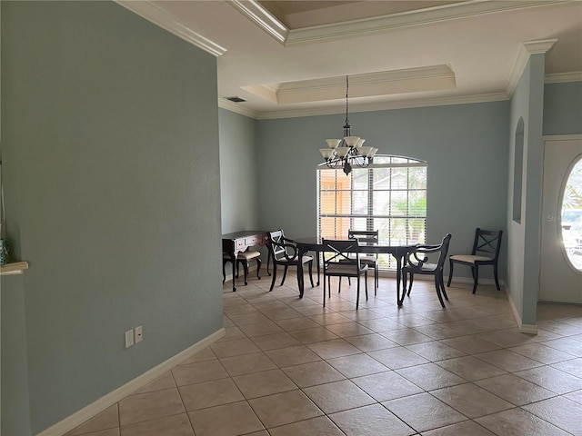 tiled dining area with an inviting chandelier, a tray ceiling, and ornamental molding