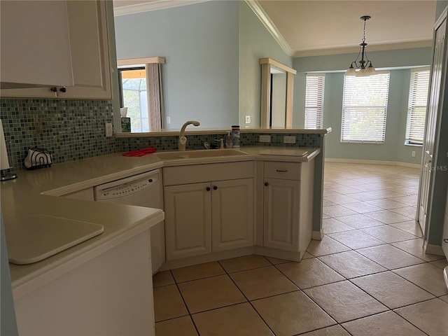 kitchen with light tile patterned flooring, sink, crown molding, pendant lighting, and decorative backsplash