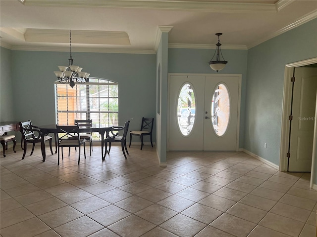 tiled entryway featuring an inviting chandelier, a tray ceiling, crown molding, and french doors