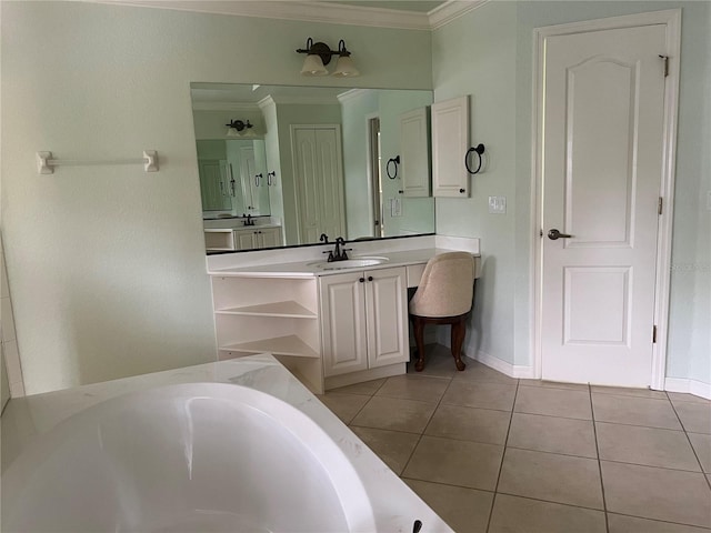 bathroom with tile patterned floors, ornamental molding, a bathing tub, and vanity