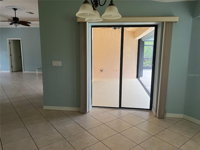 tiled empty room with ceiling fan with notable chandelier