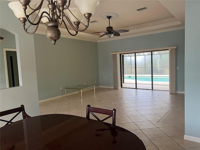 unfurnished dining area featuring light tile patterned floors, a tray ceiling, and ornamental molding