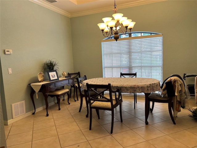 tiled dining room featuring a notable chandelier and ornamental molding