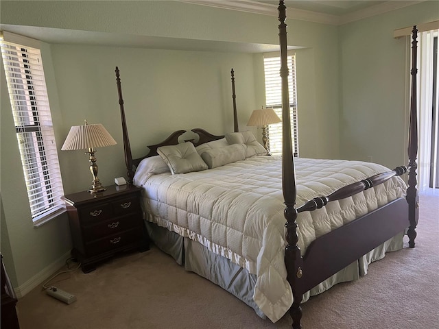 bedroom featuring ornamental molding and light colored carpet