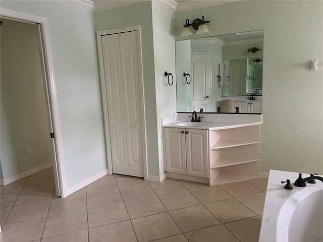 bathroom with ornamental molding, tile patterned floors, and vanity