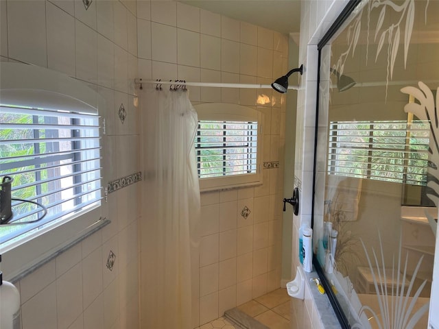 bathroom featuring walk in shower, tile patterned floors, and tile walls