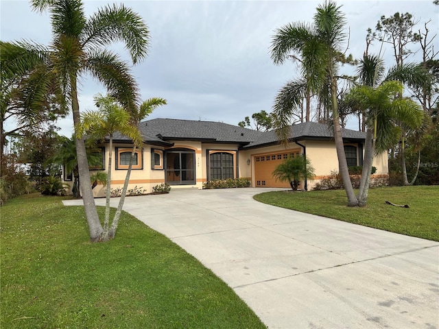 view of front of house with a garage and a front lawn