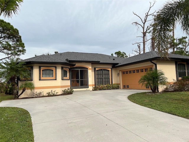 view of front of house featuring a garage and a front yard