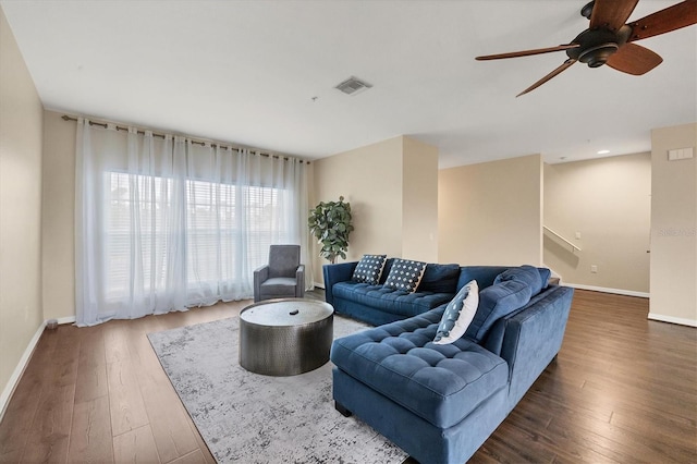 living room featuring dark hardwood / wood-style flooring and ceiling fan