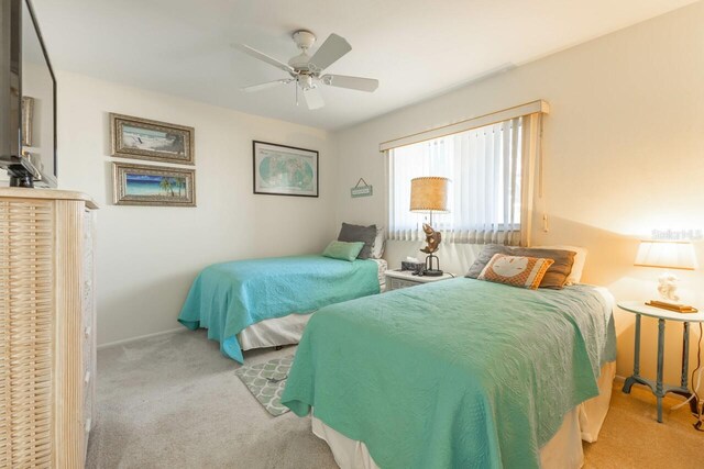 bedroom featuring light colored carpet and ceiling fan