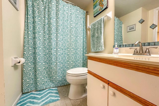 bathroom featuring vanity, hardwood / wood-style floors, and toilet