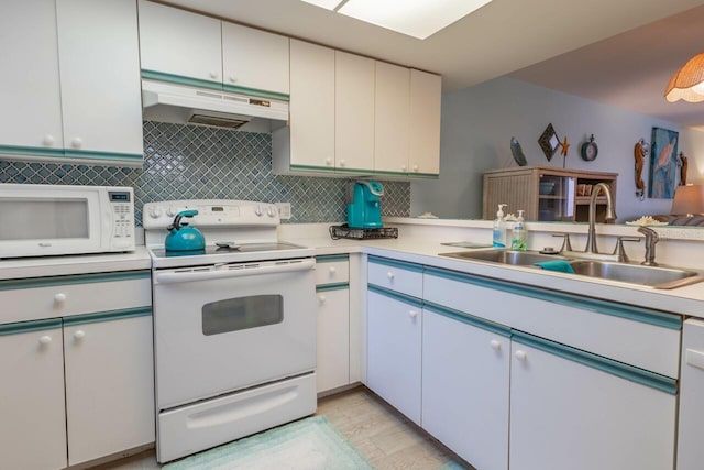 kitchen with white appliances, white cabinetry, sink, and decorative backsplash