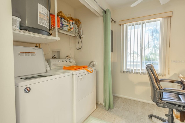 laundry room with light wood-type flooring and washing machine and clothes dryer