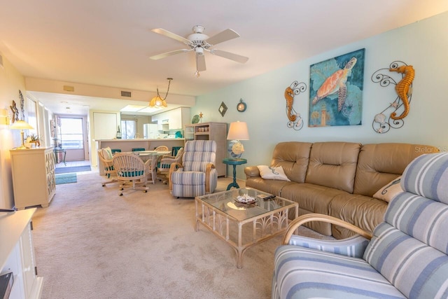 carpeted living room featuring ceiling fan