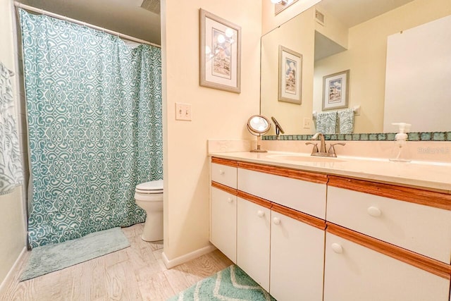 bathroom with vanity, walk in shower, and toilet