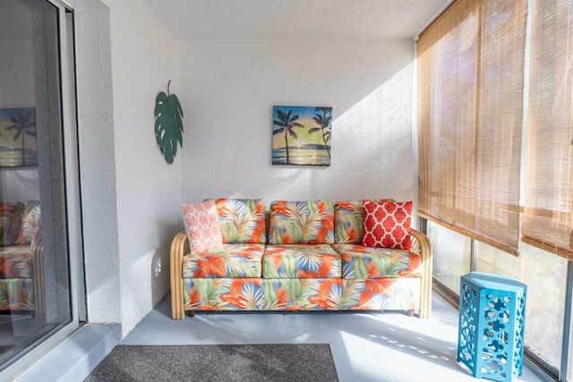 living room featuring concrete floors and plenty of natural light