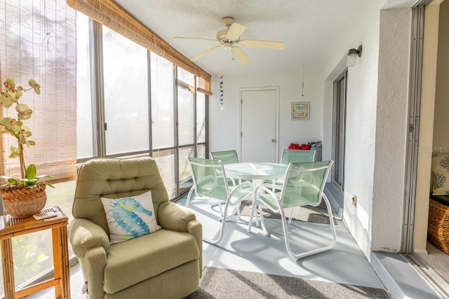 sunroom / solarium featuring ceiling fan