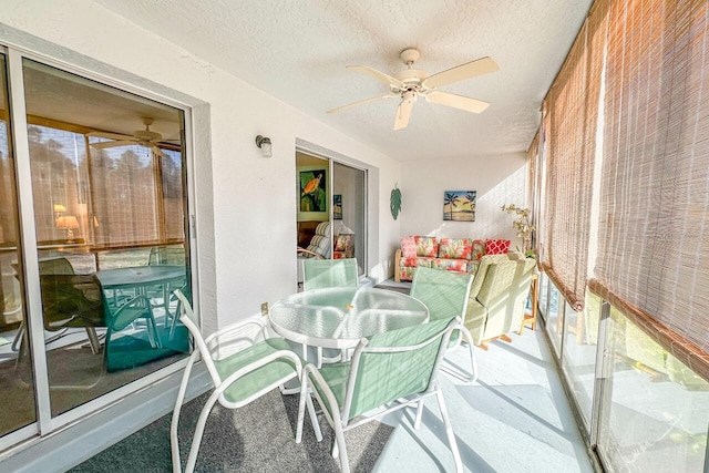 sunroom featuring ceiling fan