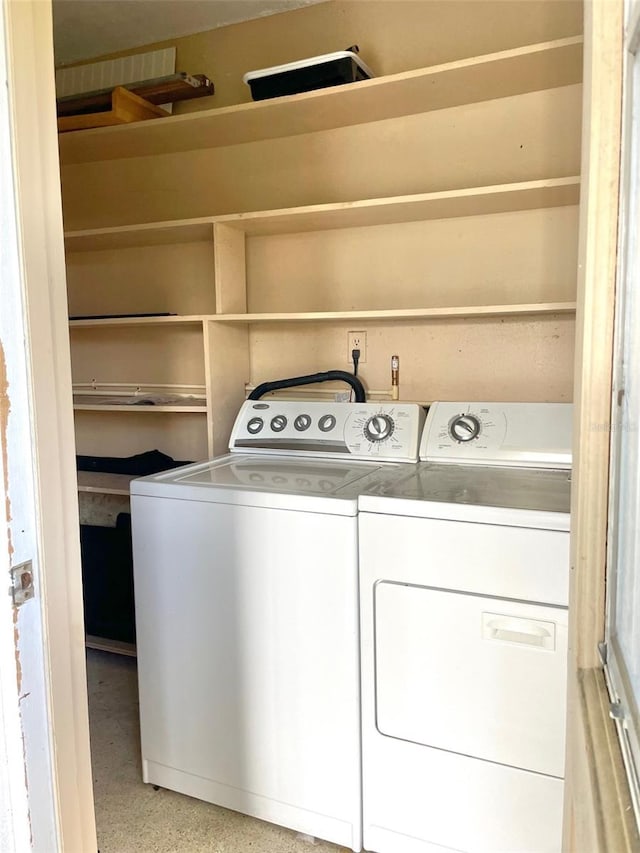 clothes washing area with washer and dryer