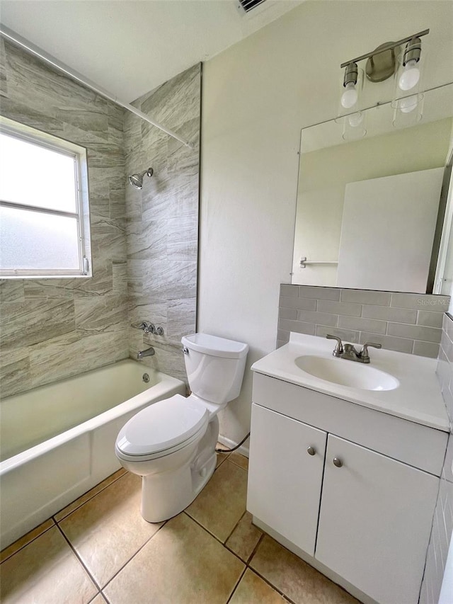 full bathroom with backsplash, toilet, vanity, tiled shower / bath combo, and tile patterned floors