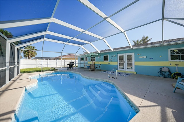 view of swimming pool with a patio area, french doors, grilling area, and glass enclosure