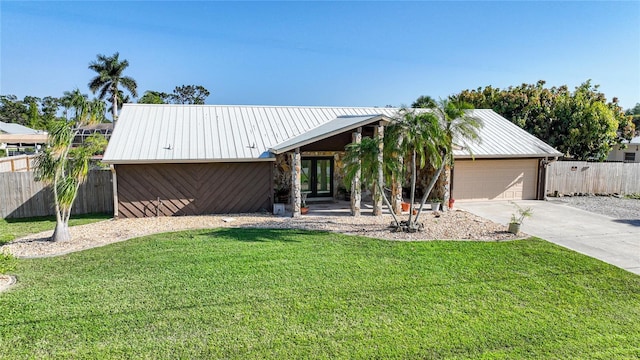 view of front of property with a garage and a front lawn