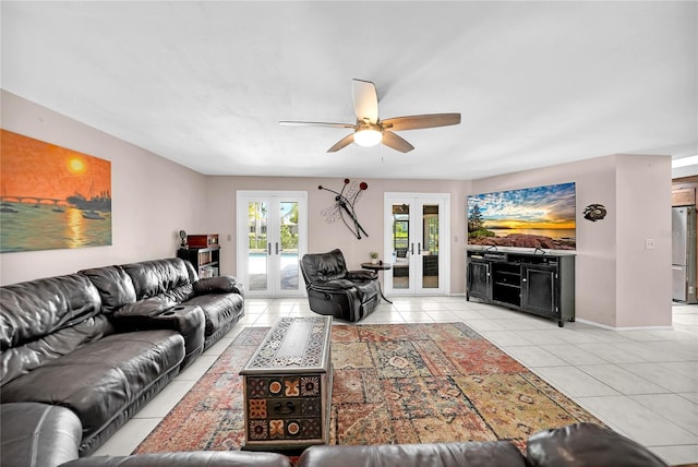 living room with french doors, ceiling fan, and light tile patterned floors