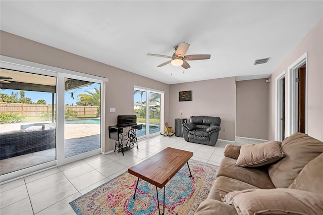 living room with ceiling fan and light tile patterned floors