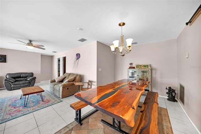 tiled dining area with ceiling fan with notable chandelier