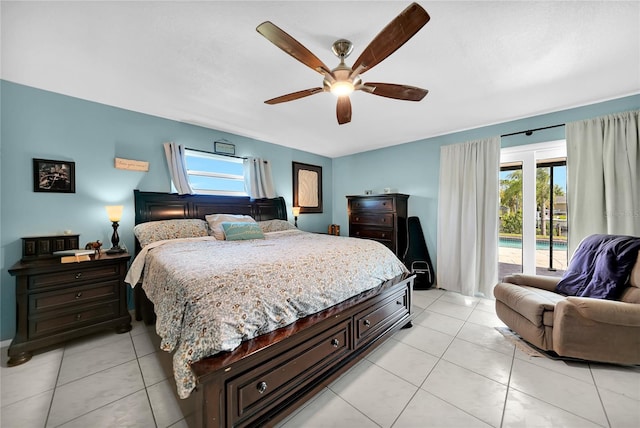 bedroom featuring multiple windows, access to exterior, light tile patterned floors, and ceiling fan