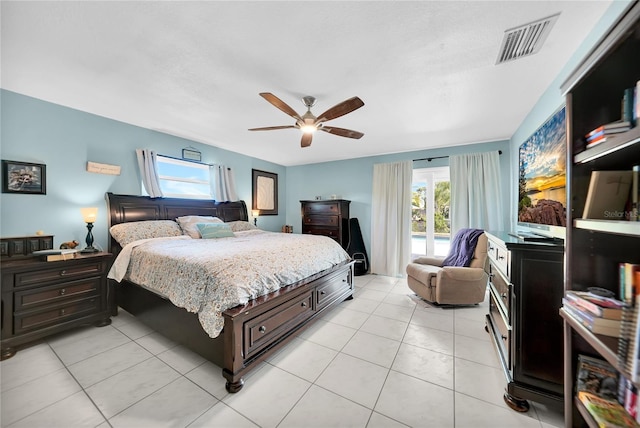 bedroom with ceiling fan, multiple windows, and light tile patterned floors