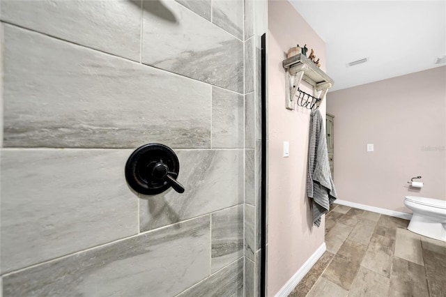 bathroom with toilet, wood-type flooring, and a shower